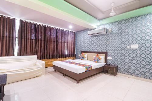 a bedroom with two beds in a room at FabHotel Sumangal in Gwalior