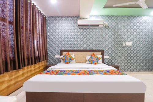 a bedroom with a bed in a room at FabHotel Sumangal in Gwalior