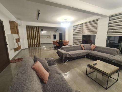 a living room with two couches and a table at Eva Luxury Villa in Lachi
