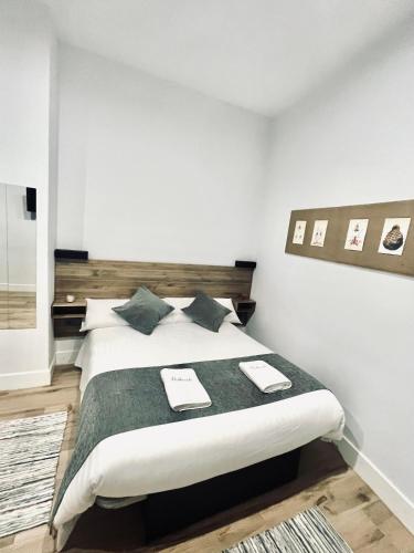 a bedroom with a large bed with two place mats on it at Balhondo Open Village in Puebla de Alcocer