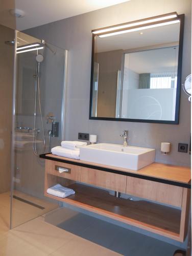 a bathroom with a sink and a mirror at Hotel Federwerk in Sankt Georgen im Schwarzwald