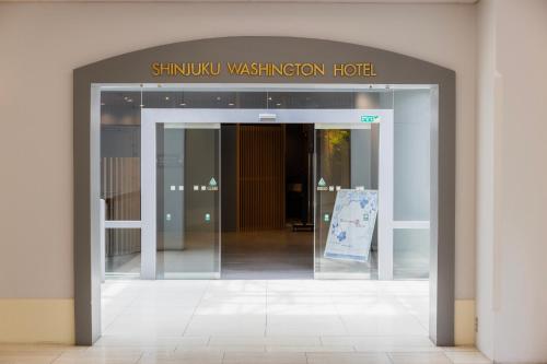 an entrance to a shimura washington hotel with an open door at Shinjuku Washington Hotel in Tokyo
