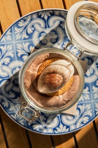 a glass jar with some bread on a blue and white plate at Hotel El Pilar Andalucia in Estepona