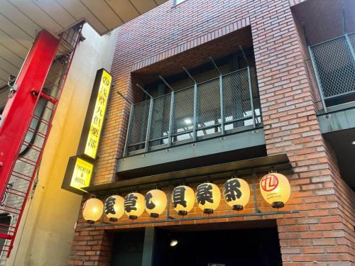 a building with a balcony withinese signs on it at Asakusa Kokono Club Hotel in Tokyo