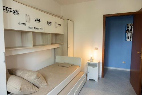 a small bedroom with a bed and a night stand at Casa via materdomini in Brindisi