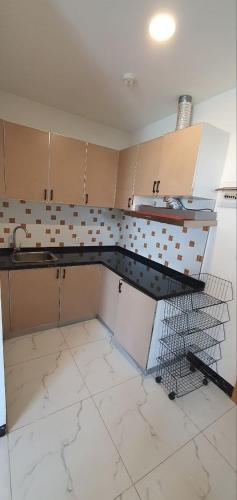 a kitchen with a sink and a counter top at Residence L two bedroom in Phnom Penh