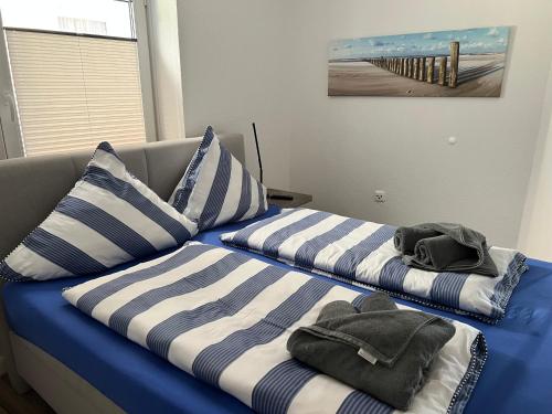 ヴァンガーオーゲにあるWoogeTraum - Traumwohnung mit Meerblick direkt am Strandのベッド2台(上段にタオル付)が備わる客室です。