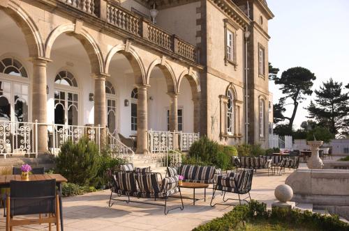 a group of chairs sitting outside of a building at Fowey Hall Hotel in Fowey