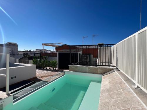 a swimming pool on the roof of a building at Arcos de Medina - Apartamentos premium in Córdoba