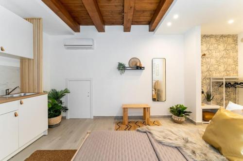 a living room with white walls and a wooden ceiling at Baglio Delle Terre Nere - Affitti Brevi Italia in Viagrande