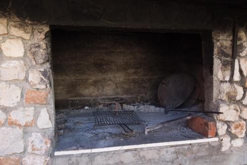 a brick oven with a large metal object in it at Villa Dubravka in Mlini