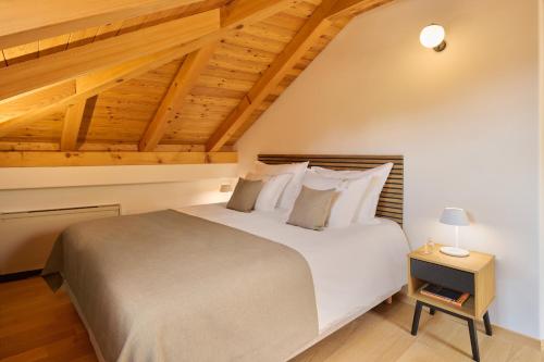 a bedroom with a large bed and wooden ceilings at Palace Natali in Dubrovnik