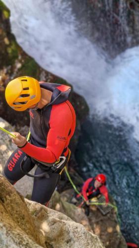 a man in a helmet on top of a waterfall at WALNUT TREE VILLA in Archanes