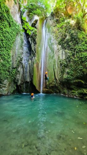 a person standing in front of a waterfall at WALNUT TREE VILLA in Archanes