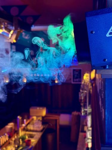 a bar with blue and green smoke on the ceiling at Lexenhof in Nussdorf am Attersee
