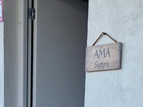 a sign that reads ama surprise hanging on a wall at La Mata primera línea de playa in Torrevieja
