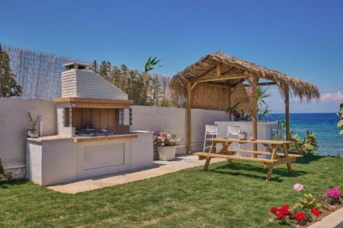 a backyard with a picnic table and a gazebo at Ducato di Zante Luxury Beach Villa, by ZanteWize in Kipseli