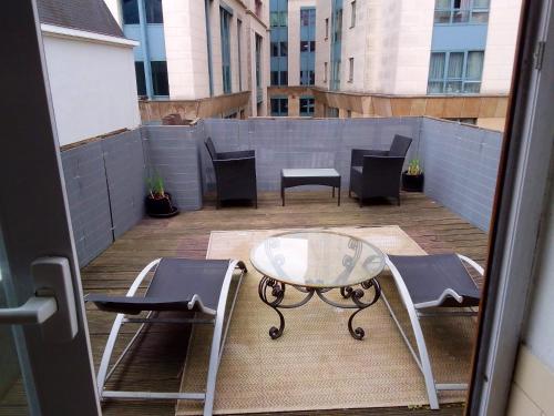 a balcony with chairs and a table and chairs at 2 bedrooms appartement with wifi at Bruxelles in Bons Villers