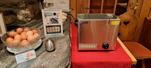 a counter with a mixer and a bowl of eggs at Sporthotel Victoria in Gstaad