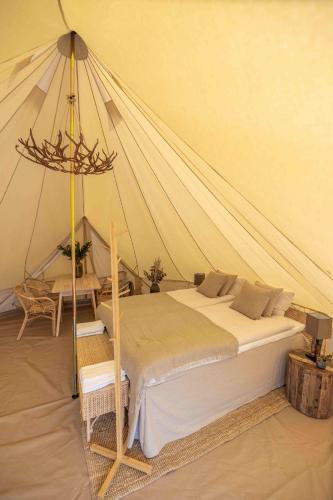 a bedroom with a bed in a tent at Camp Gielas, Arvidsjaur in Arvidsjaur