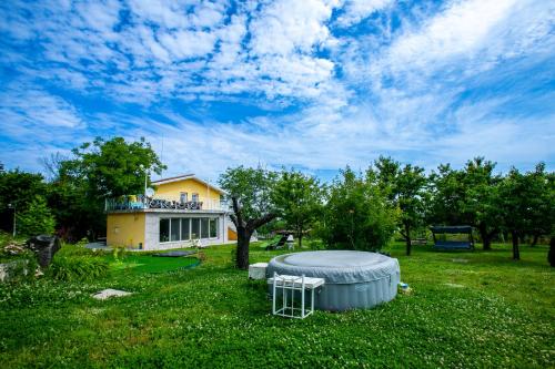a house with a hot tub in a yard at Къща за гости Кала in Patalenitsa