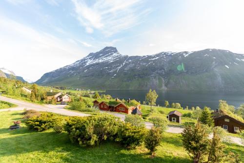a village with a lake and mountains in the background at Cabin near the lake in Årset