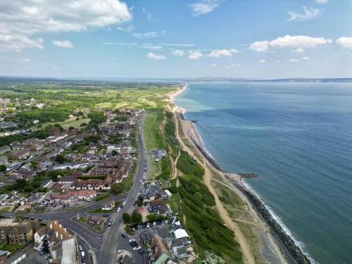 an aerial view of a beach and the ocean at 3TheDome - Luxury Ground Floor Apartment opposite the Beach, Barton on Sea in Barton on Sea