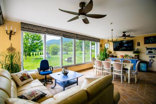 a living room with a couch and a table at Къща за гости Кала in Patalenitsa