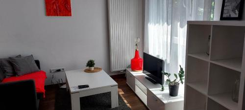 a living room with a couch and a tv and a table at Cube Apartamenty in Lublin