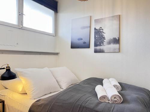 a bedroom with a bed with two towels on it at One Bedroom Apartment In Valby, Langagervej 64, 3 in Copenhagen