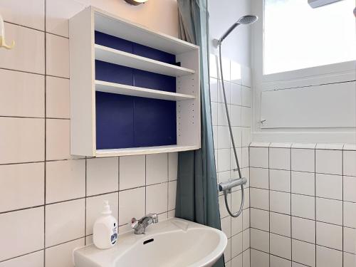 a bathroom with a sink and a shower at One Bedroom Apartment In Valby, Langagervej 64, 3 in Copenhagen