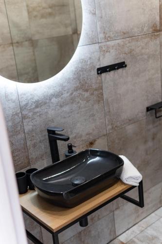 a bathroom with a black sink and a mirror at Beautiful Apartments With Parking In a Quiet Location in Ostrava