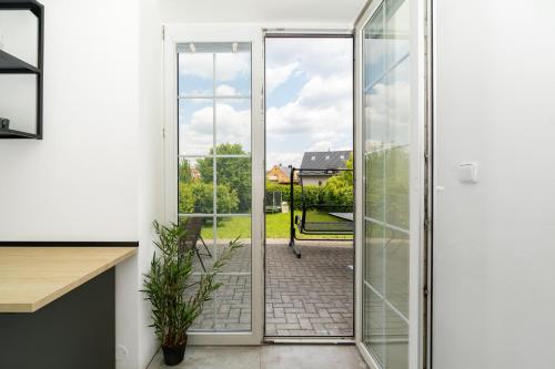 a sliding glass door leading to a patio at Beautiful Apartments With Parking In a Quiet Location in Ostrava