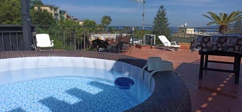 a hot tub in a patio with a table and chairs at La Terrazza Quisisana Sorrento Coast in Castellammare di Stabia