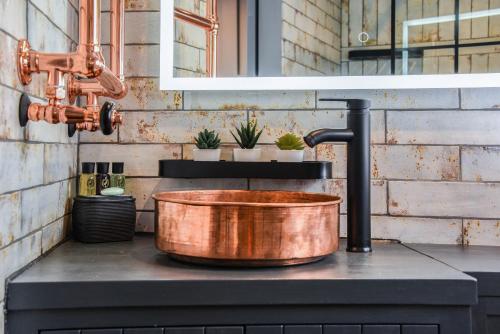 a copper bucket sitting on top of a stove at The Hideaway 