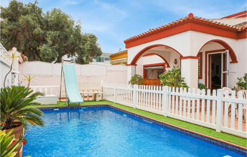 a pool in front of a house with a white fence at Gorgeous Home In Pilar De La Horadada in Pilar de la Horadada