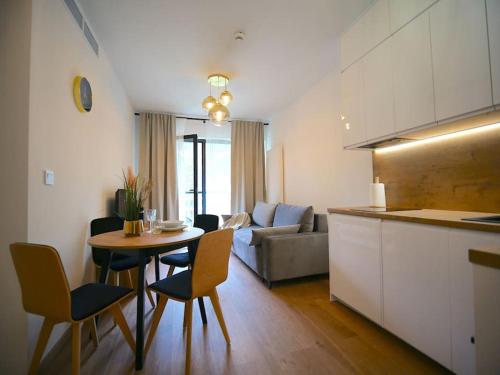 a kitchen and a living room with a table and chairs at Rogowo 117J Shellter Apartments in Rogowo