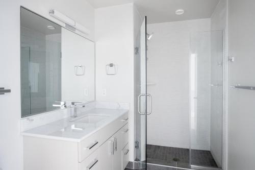 a white bathroom with a sink and a shower at NoMa jr 1br w gym patio wd nr Union Market WDC-687 in Washington