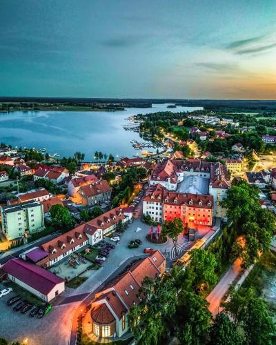 an aerial view of a city with a river at Hotel Zamek Ryn in Ryn