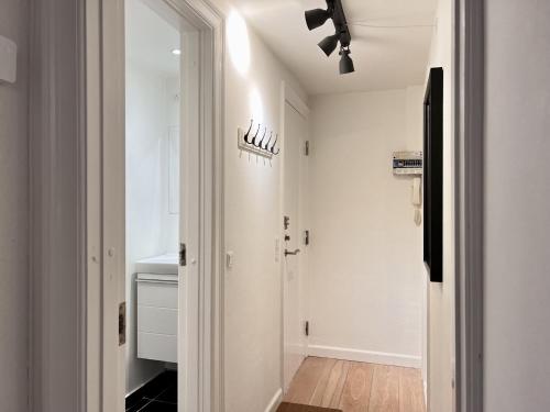 a hallway with a door leading into a room with white walls at Two Bedroom Apartment In Copenhagen, Amagerbrogade 93, in Copenhagen