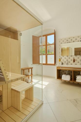 a bathroom with a glass shower and a sink at Palace Natali in Dubrovnik
