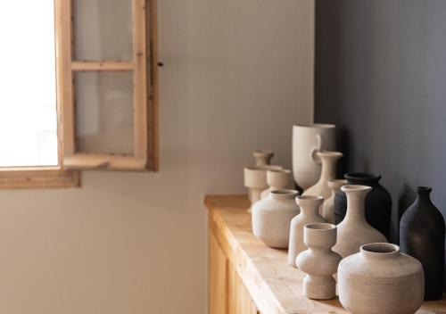 a group of white vases sitting on a table at Scorpios Beach in Monolithos