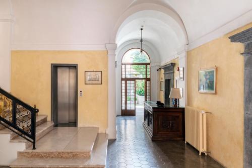 a hallway with a staircase and an archway at Hotel Posta in Orvieto