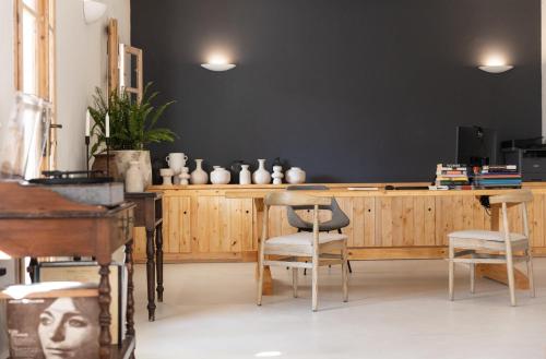a dining room with a black wall and a table and chairs at Scorpios Beach in Monolithos