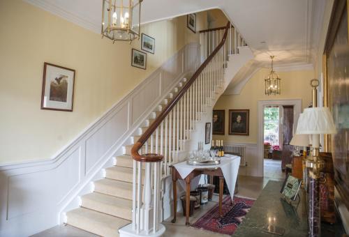 a staircase in a living room with a table at The Vean in Mevagissey