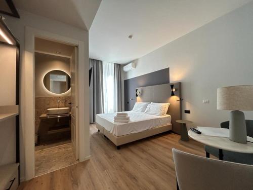a bedroom with a bed and a bathroom with a sink at Hotel Porta Pia in Rome