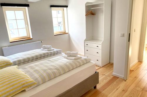 two beds in a bedroom with two windows at Nice Apartment in Eschborn in Eschborn