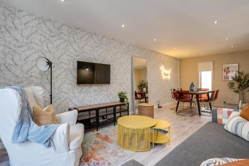 a living room with a couch and a table at Central Belfast Apartments: Citygate in Belfast