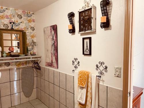 a bathroom with a shower and a clock on the wall at Cozy Apartment Villas in Rosarito