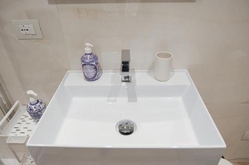 a white sink with two blue and white vases on it at Supernova in Savona